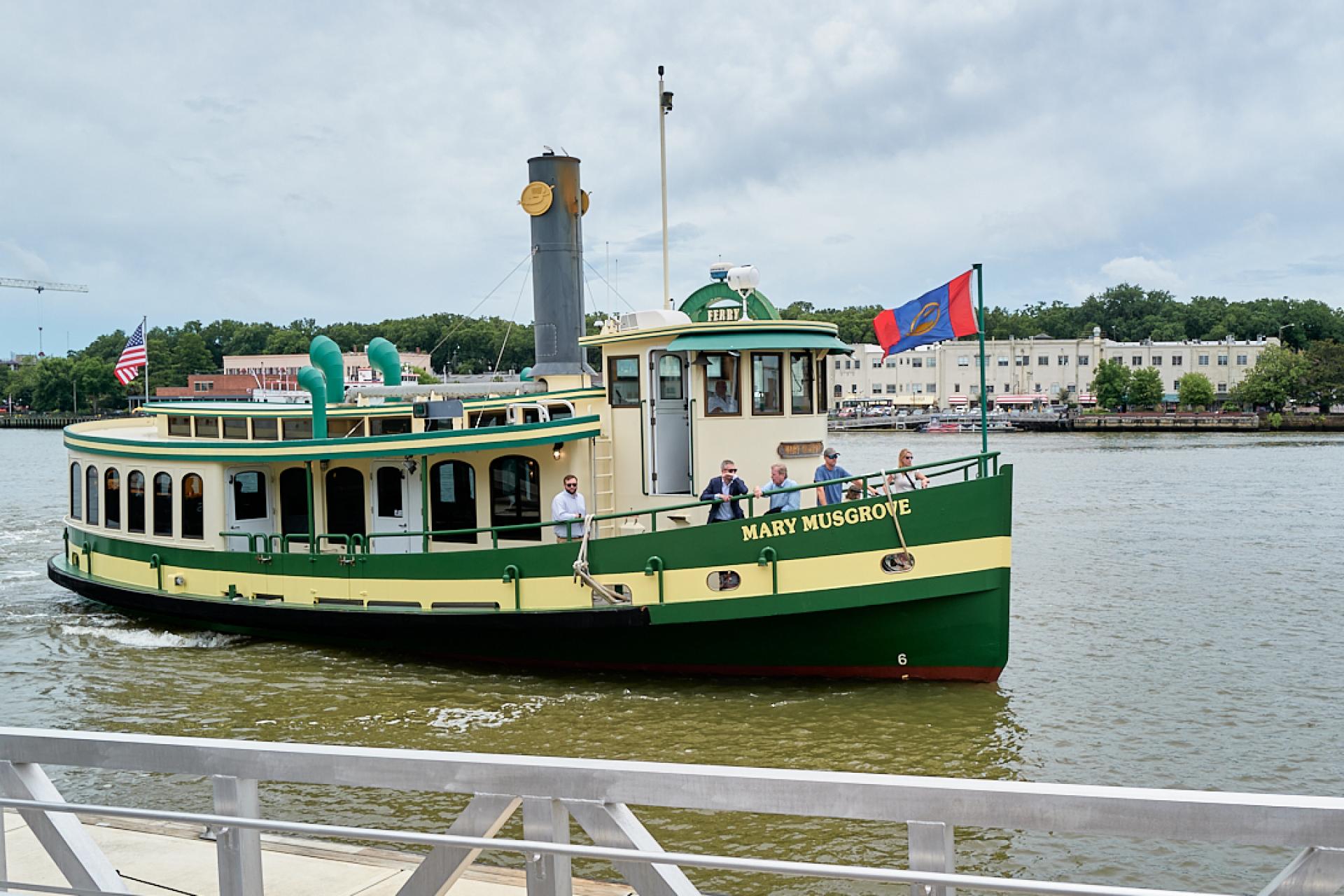 Green and white boat taxi on the river